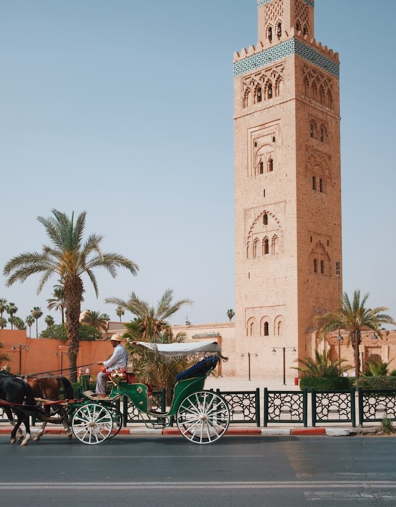 Koutoubia Mosque and traditional horse carriage in Marrakech Morocco