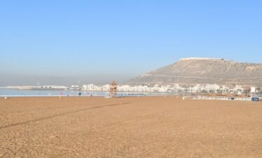 a beach with a mountain in the background