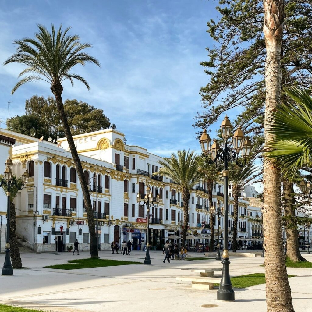 a large white building surrounded by palm trees