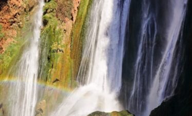 waterfalls on brown rocky mountain during daytime