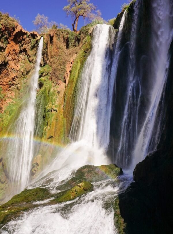 waterfalls on brown rocky mountain during daytime
