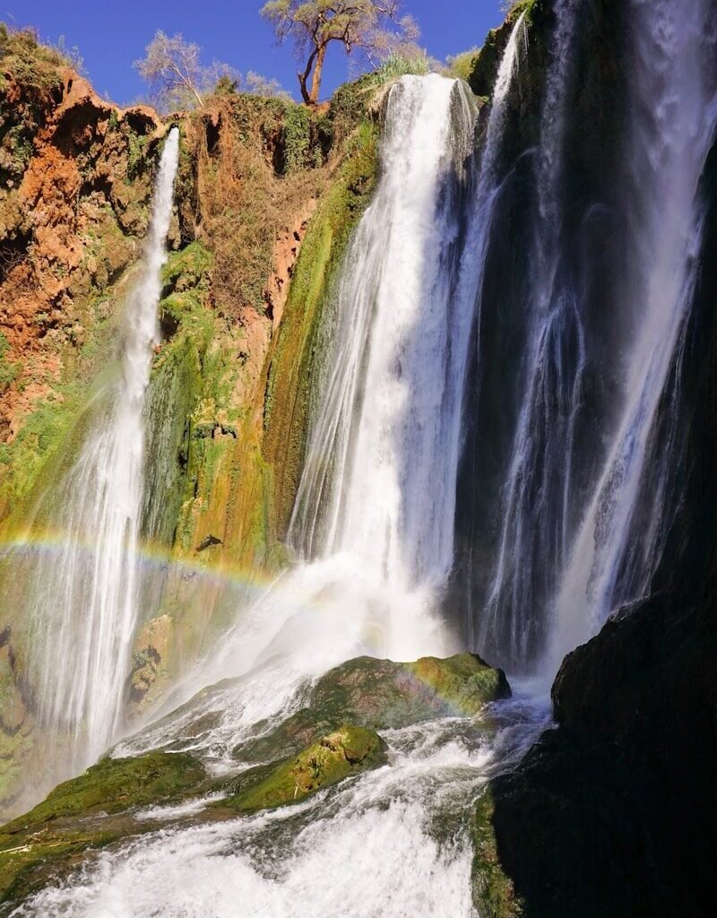 waterfalls on brown rocky mountain during daytime