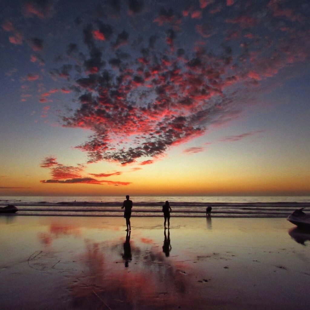 two person standing on shore
