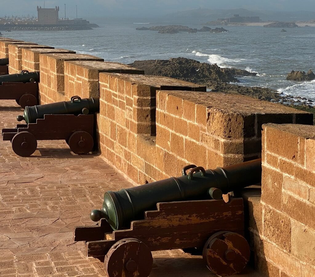 a brick wall with cannons on it