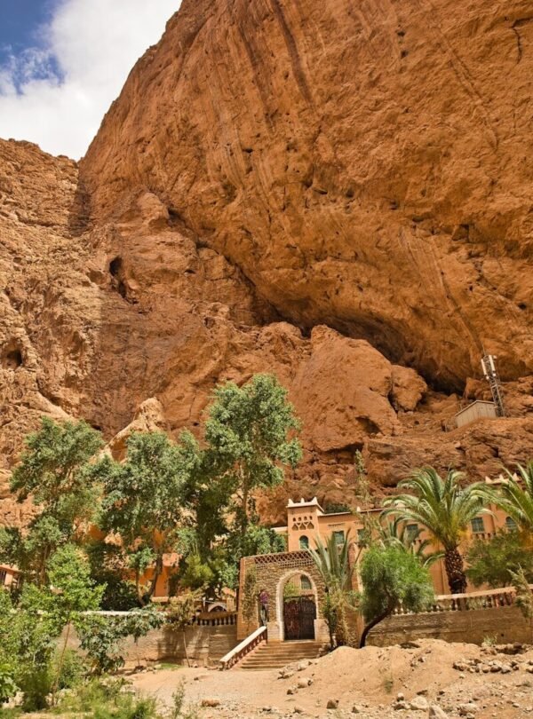 A large rock formation with a building in the middle of it