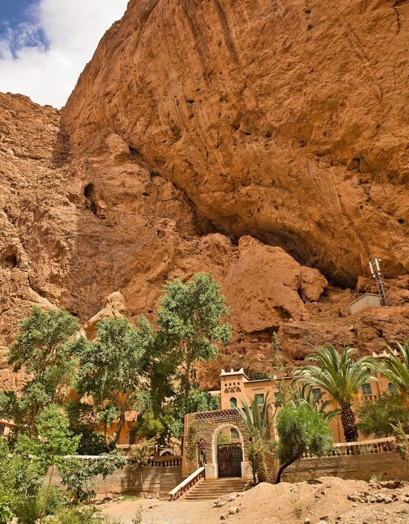 A large rock formation with a building in the middle of it