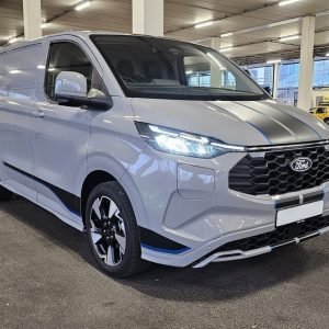 A modern gray ford transit van parked outdoors.